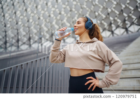 Active lifestyle. Young fitness woman exercising and stretching outdoors. Sports, sports training. 120979751