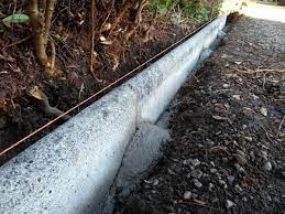 The most popular edging materials are pavers or blocks, though concrete is sometimes used as well. Laying Concrete Kerbs Along A Driveway Dengarden