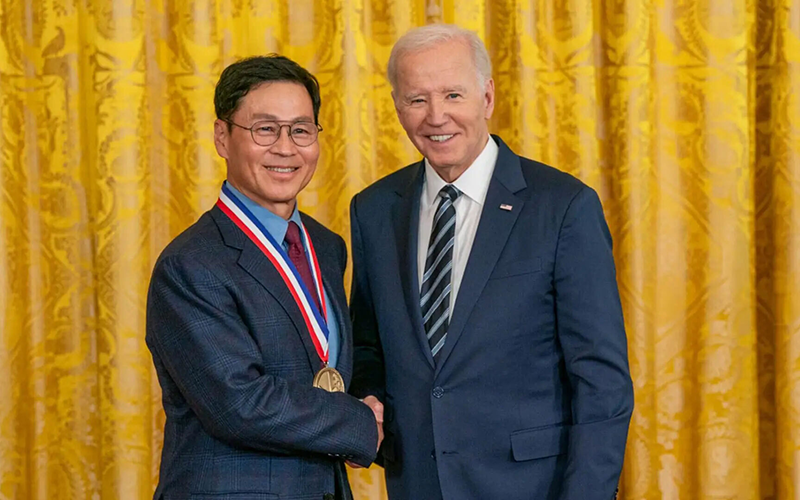 President Joe Biden shaking Kim Jeong's hand while posing for photograph