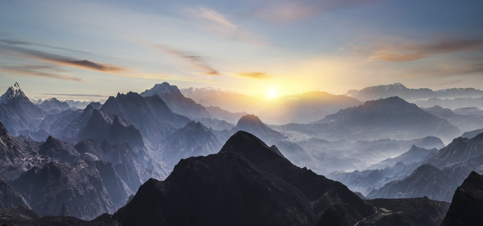 Aerial view of misty mountains at sunrise