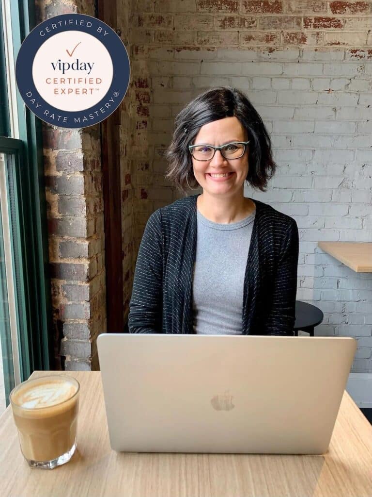 Erin Ulrich Creative, VIP Day Certified Expert, sitting at table with computer and coffee.