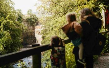 A family looking at High Force waterfall