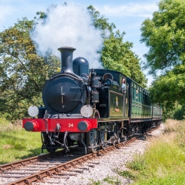 Steam train riding on the tracks at Isle of Wight Steam Railway