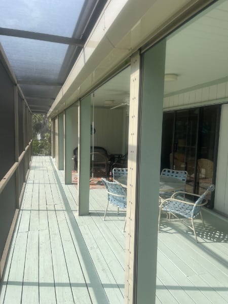 Rolling shutters installed across the width of a screened in porch and lanai in Sanibel Florida. 