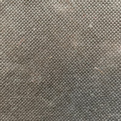 Extreme close up of dirty grey colored paper with visible corrugated pattern