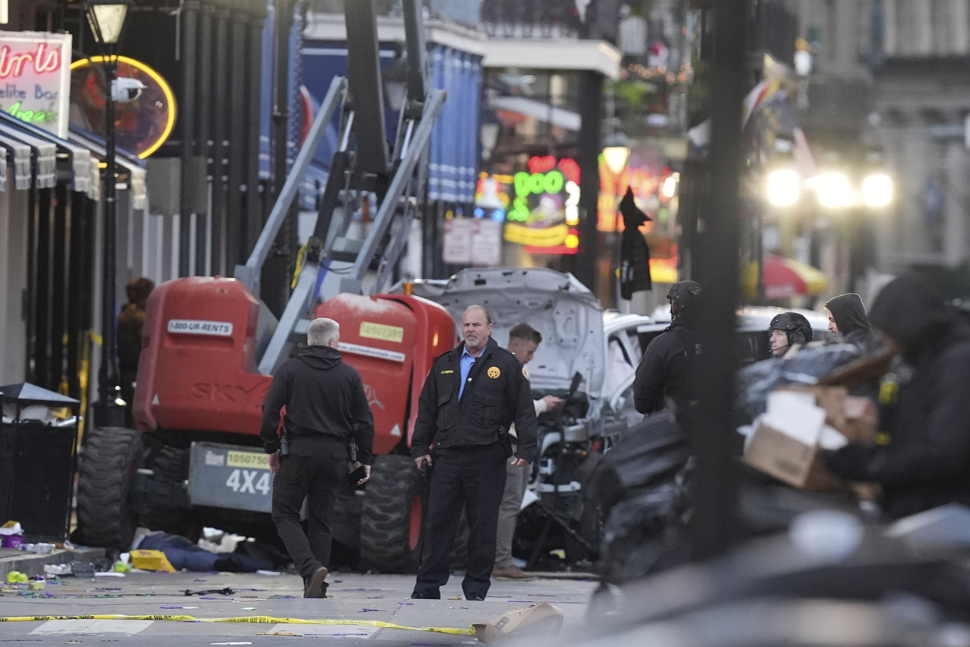 Security personnel investigate the scene on Bourbon Street after a vehicle drove into a crowd on New Orleans' Canal and Bourbon Street.