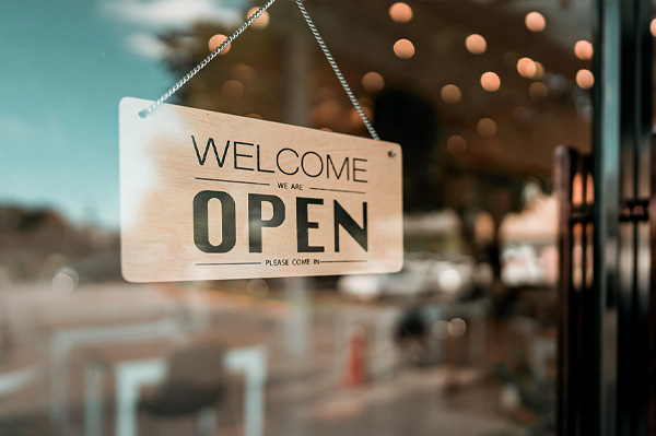 shop sign in a window that says "open"