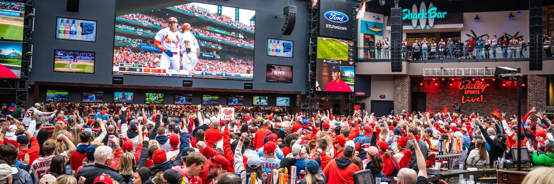 Cardinals fans watch the game on the gigantic screen at Ballpark Village.