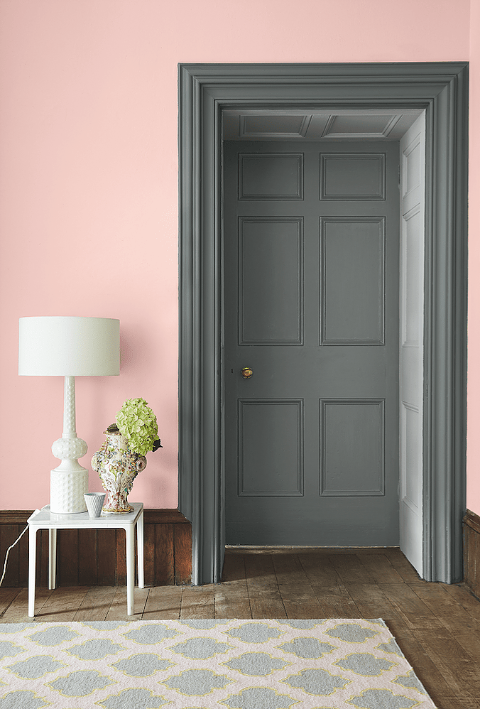 Grey door with soft pink walls.