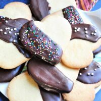 Chocolate dipped heart shaped cookies with sprinkle topping.