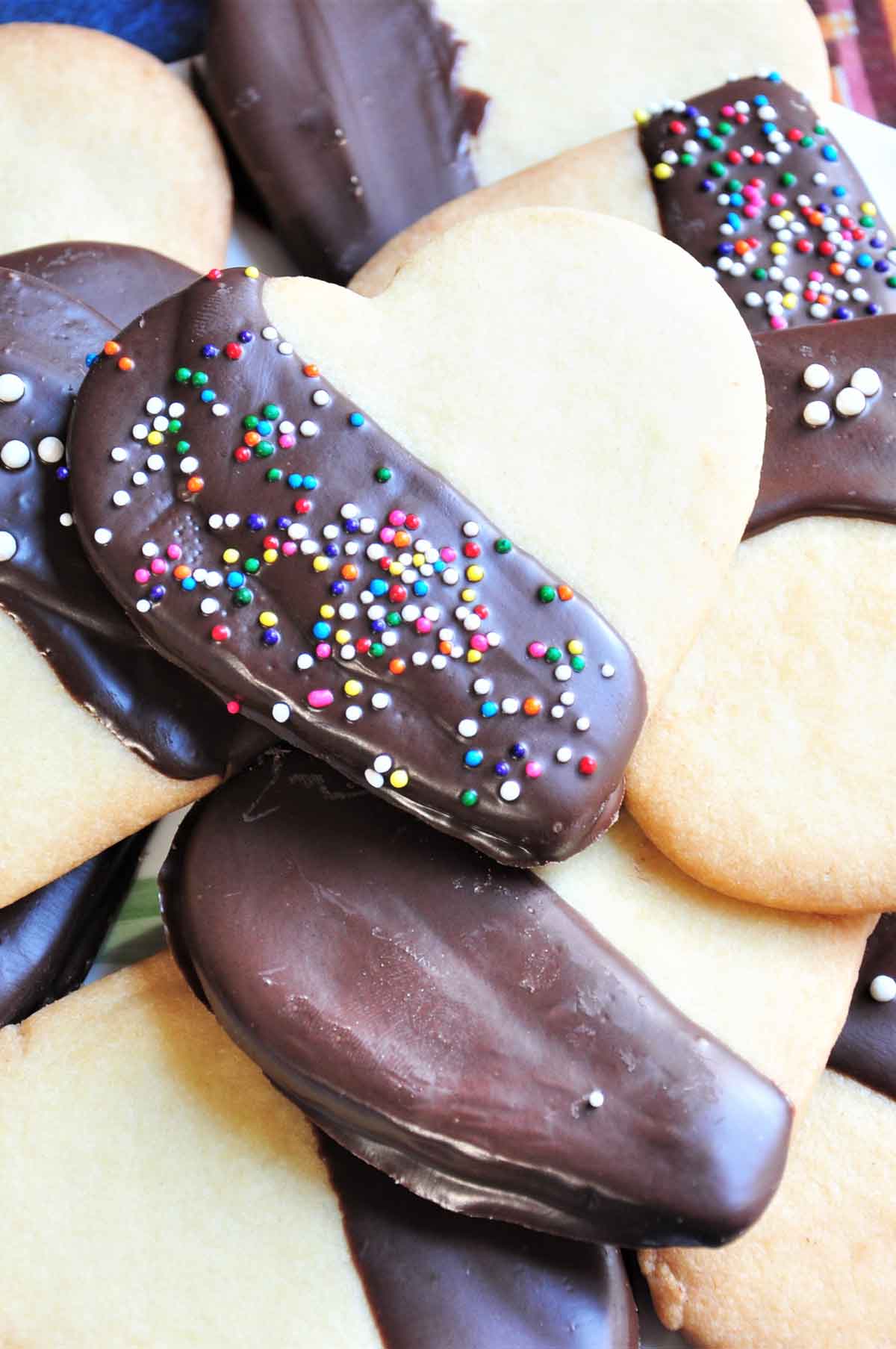 Chocolate dipped heart shaped cookies with sprinkle topping.