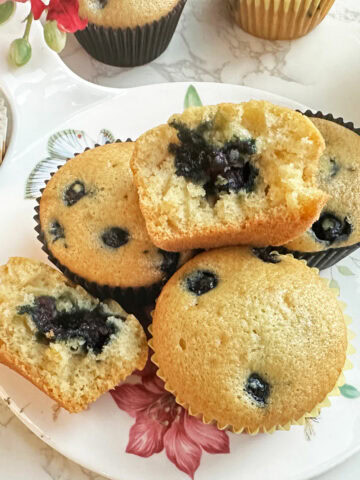 Blueberry muffins on a serving platter.