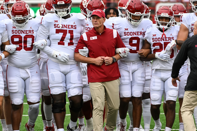 Brent Venables leads his team out to warm up against Nebraska.