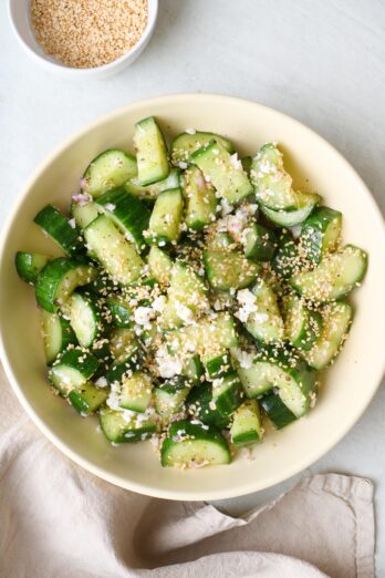 Smashed cucumber salad with sesame seeds and crumbled feta.