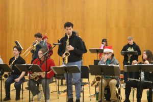 Playing the saxophone, senior Dominic Dupei is performing a solo. On Dec. 17, the FHS Jazz Band put on a holiday performance for the school to show their peers their talents. 