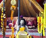 A sadhu worships at his place at Panchayati Shree Niranjani Akhada Chaavni