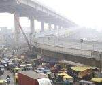 Vehicles ply on road amid cold and foggy winter morning