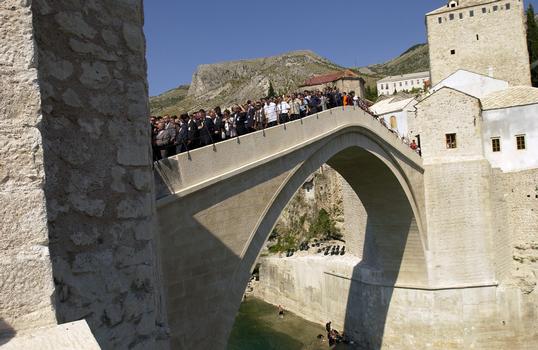 Old Mostar Bridge after reconstruction : Local citizens walk over the Old Bridge (Stari Most) for the first time during the grand opening ceremony celebrating the re-opening of this bridge in Mostar, Herzegovina-Neretva Canton, Bosnia-Herzegovina (BIH). This bridge is the symbol of Mostar and was destroyed during the 1993 Balkan War