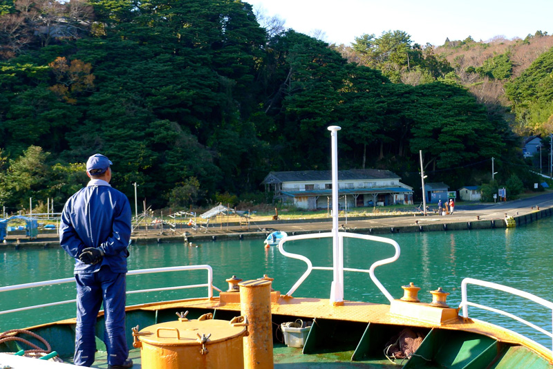 man looking toward tashirojima from boat