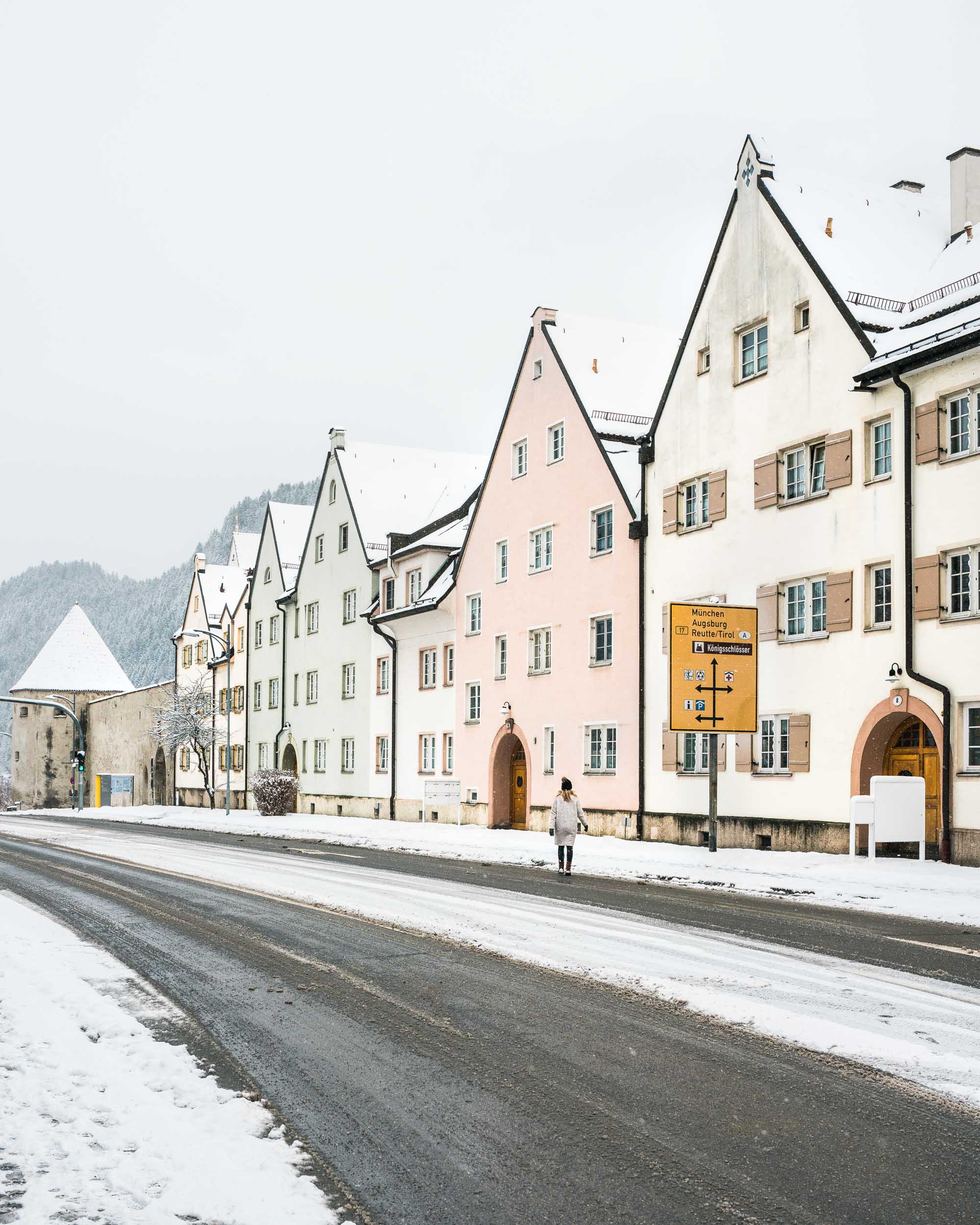 Travel blogger Selena Taylor in the pastel town of Fussen near Neuschwanstein Castle in Germany