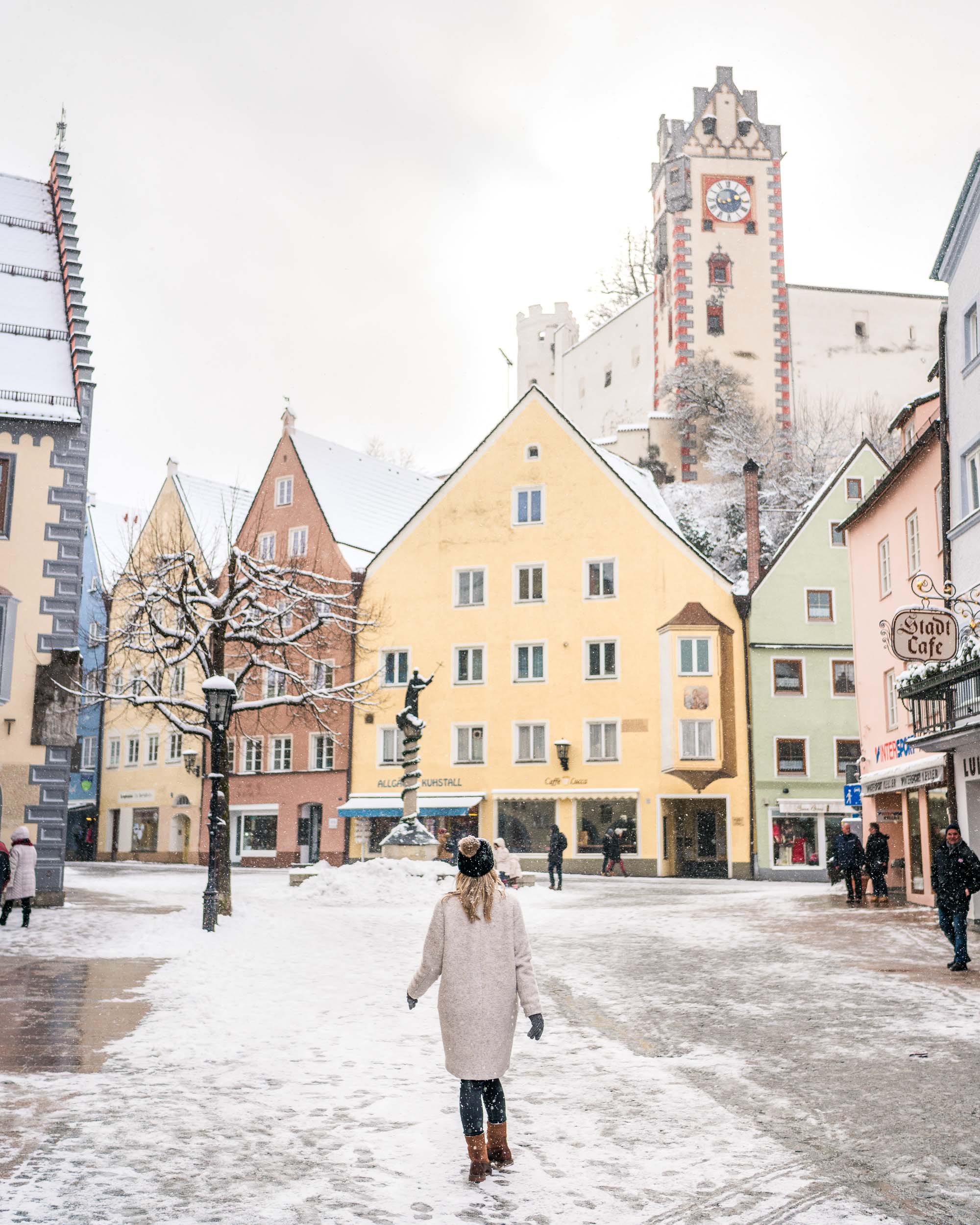 Travel blogger Selena Taylor in the pastel town of Fussen near Neuschwanstein Castle in Germany