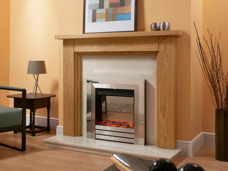 Stepped oak fireplace surround in light oiled oak against an orange chimney, fitted with a chrome electric fire.