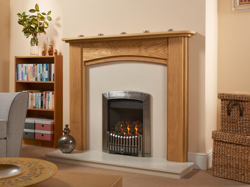 Solid oak arched fire surround finished in light oiled oak with a marble back panel and hearth and contemporary gas fire.