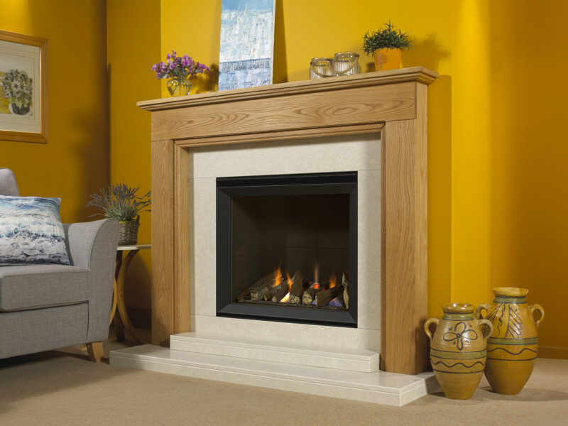 Dorchester oak fireplace in light oiled oak and a hole in the wall gas fire fitted on a cream carpet.