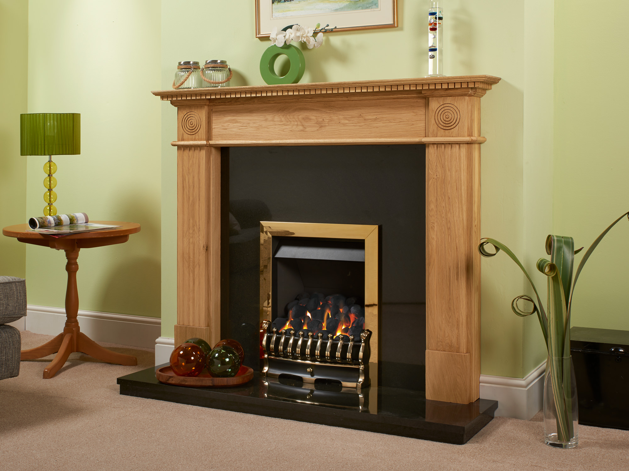 Complex Oak fireplace surround with teething fitted against a lime green wall and on top of a cream carpet.