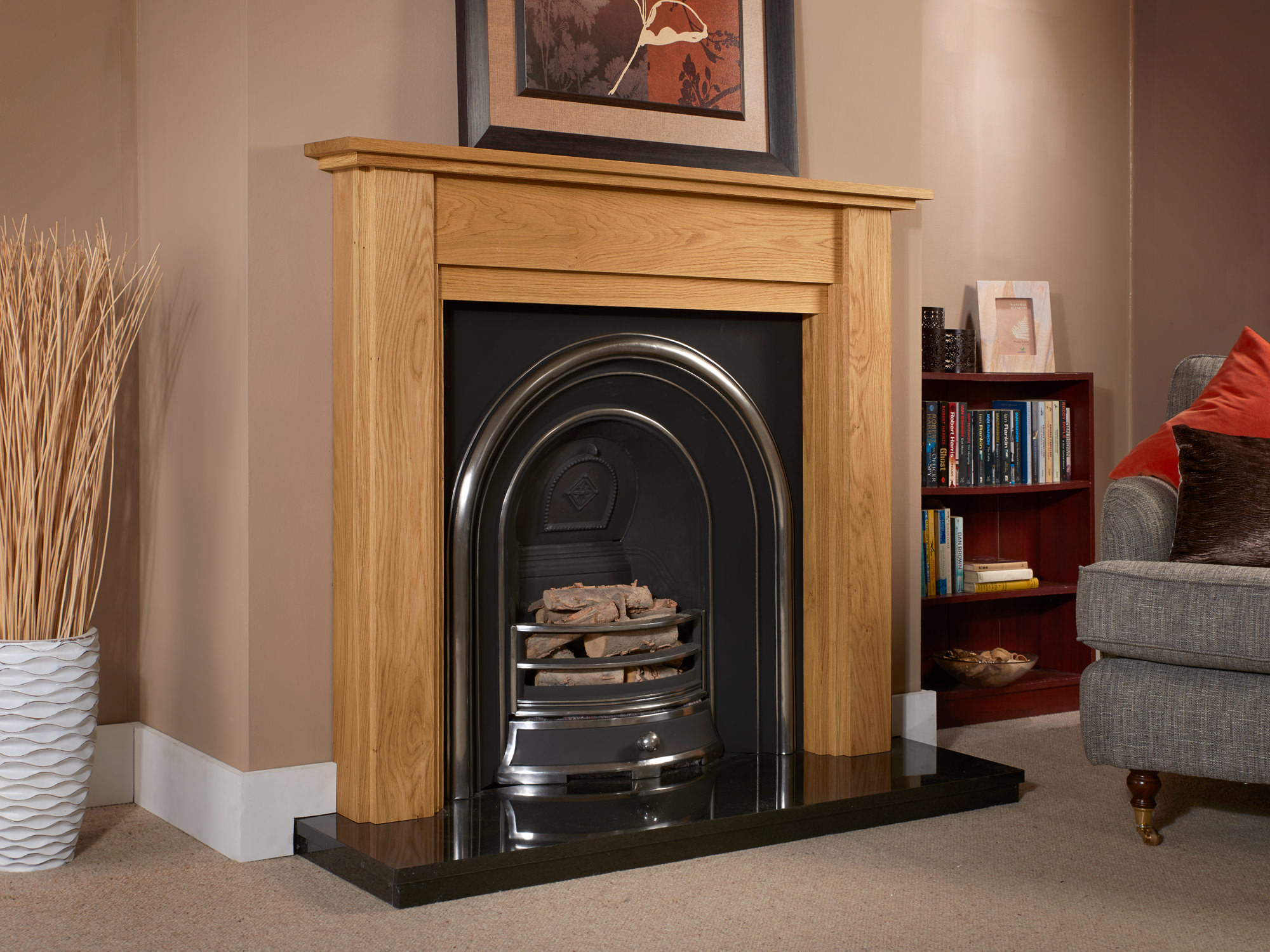 Oak fireplace surround finished in light oiled oak complete with a highlighted cast iron and a polished granite hearth.