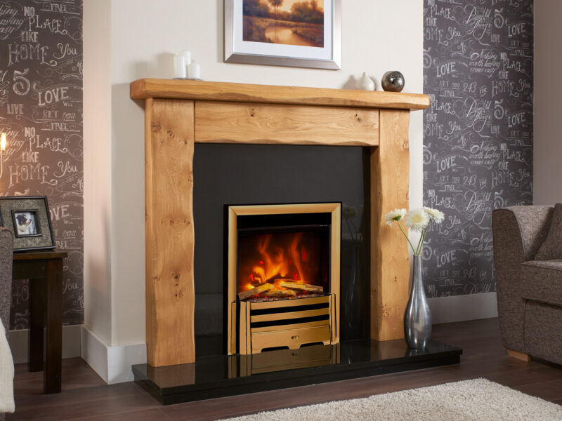 Rustic oak fireplace surround in light oiled oak on a white wall with a dark brown laminate flooring.