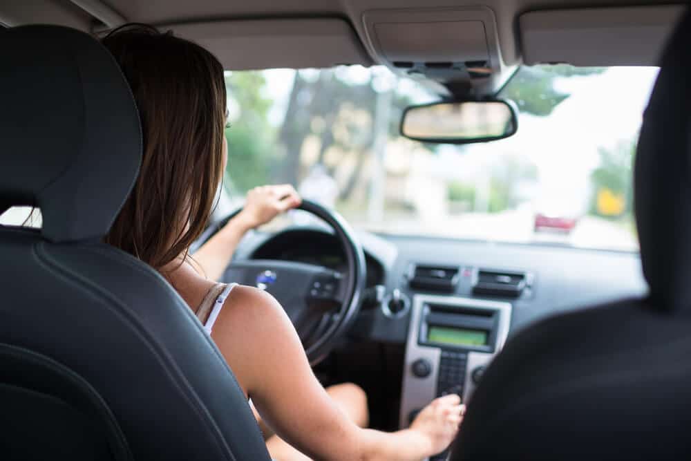 Young woman driving a rental car