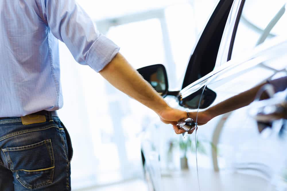 Man opening the door of a rental car