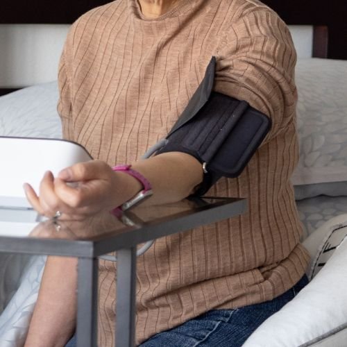 old woman using blood pressure monitor