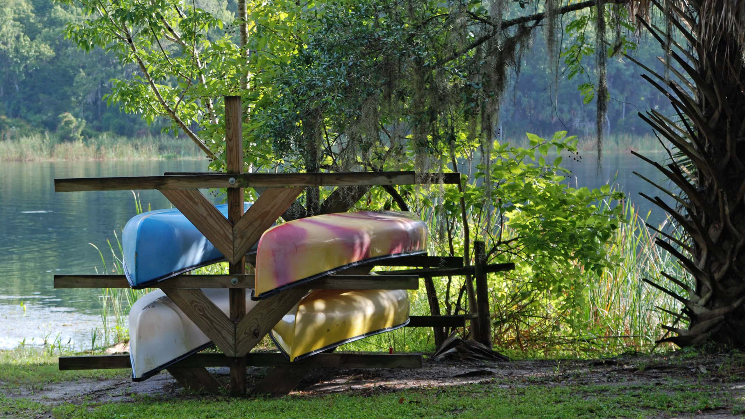 Kayaks on a rack next to a Florida stream