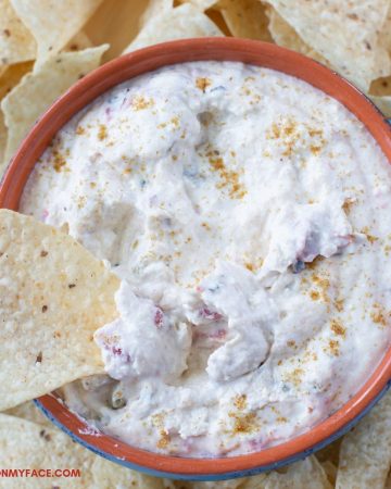 White Queso dip in a dip bowl with chips.