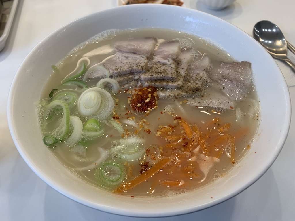 a bowl of soup with meat and vegetables