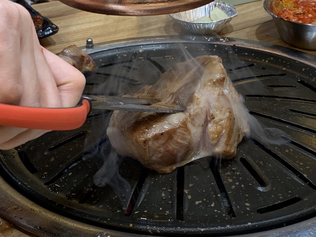 a chicken being cooked on a grill