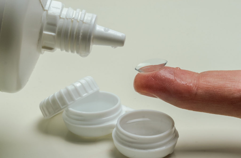 A close-up of a contact lens being cleaned using a cleaning solution.