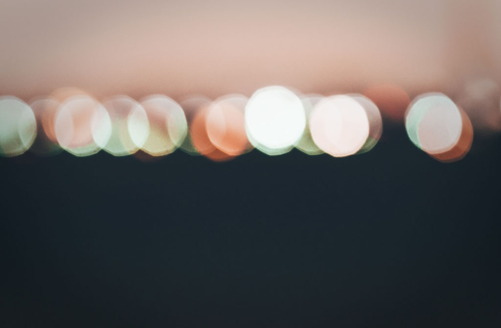 A point-of-view shot of a person who is seeing city lights as blurry halos.