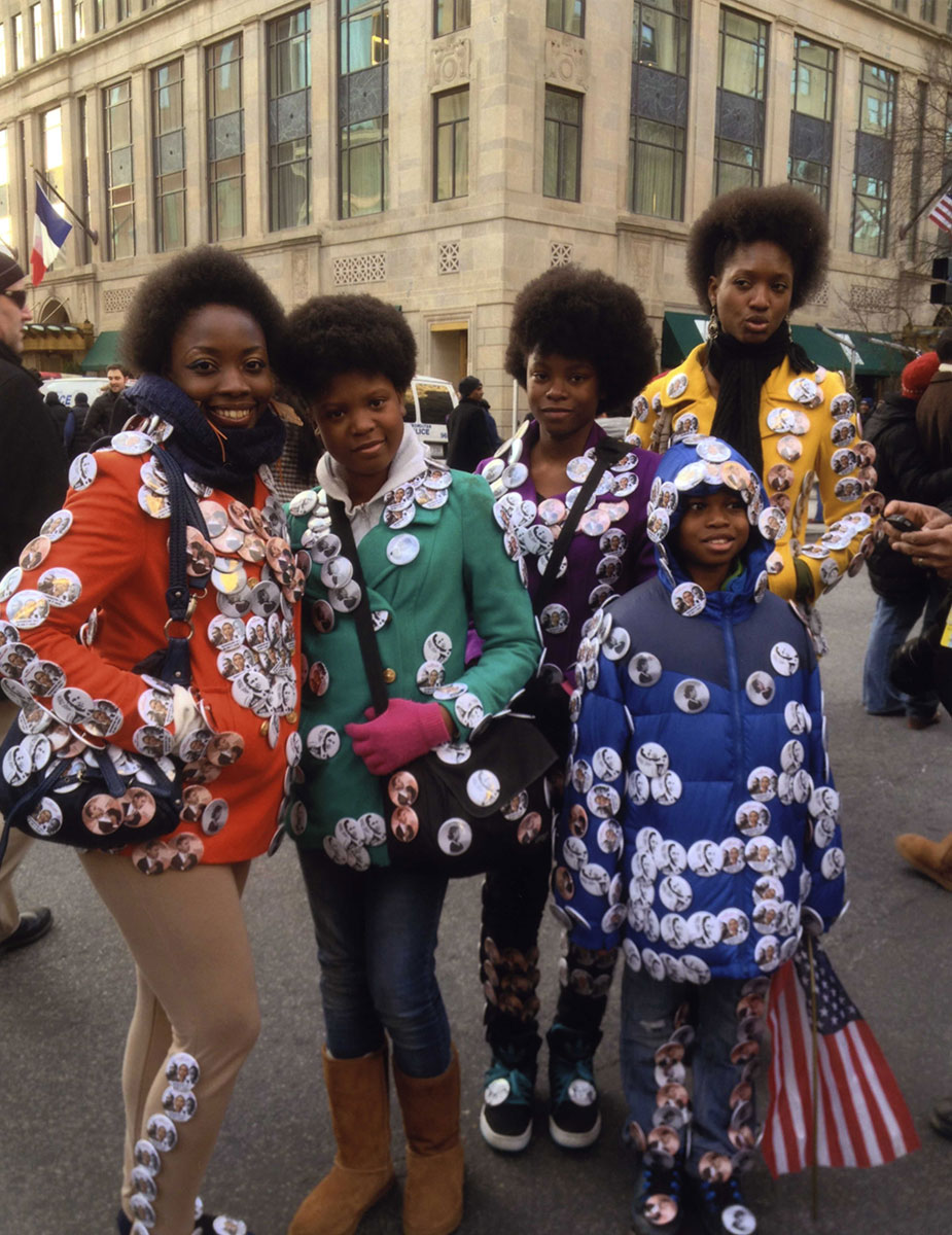 Young people at the 2013 inauguration of President Barack Obama adorn themselves with campaign buttons.