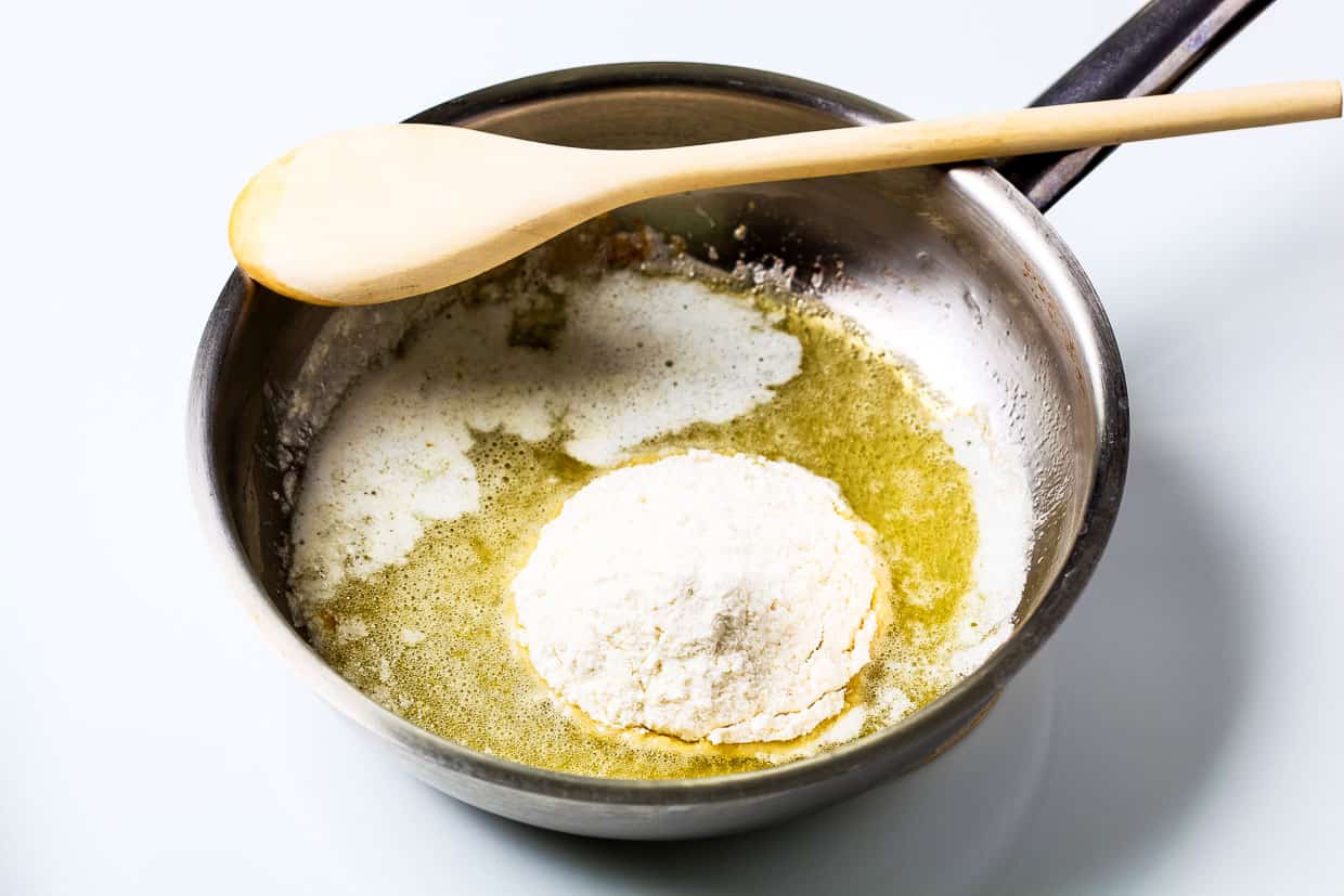 Wheat flour and heated butter in a saucepan to make a roux for a bechamel.