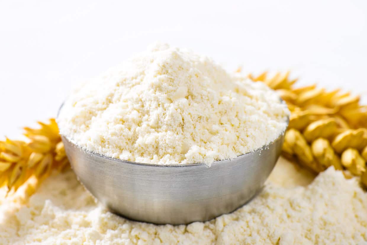 Close up of wheat flour in silver bowl.