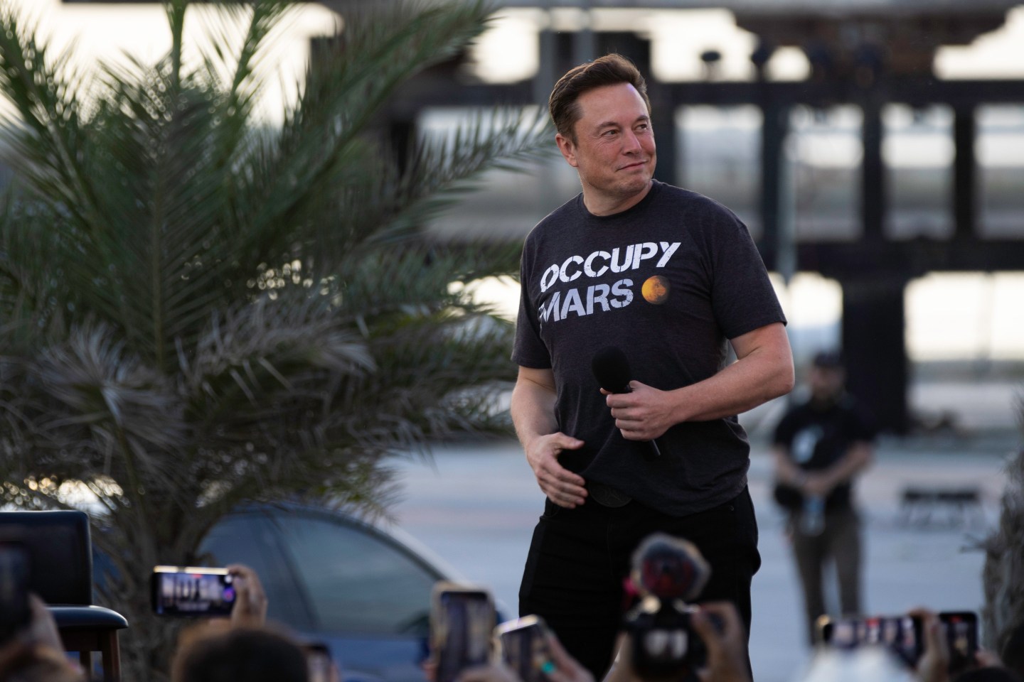 SpaceX founder Elon Musk walks on stage during a T-Mobile and SpaceX joint event on Aug. 25, 2022, in Boca Chica Beach, Texas. The two companies announced plans to work together to provide T-Mobile cellular service using Starlink satellites.