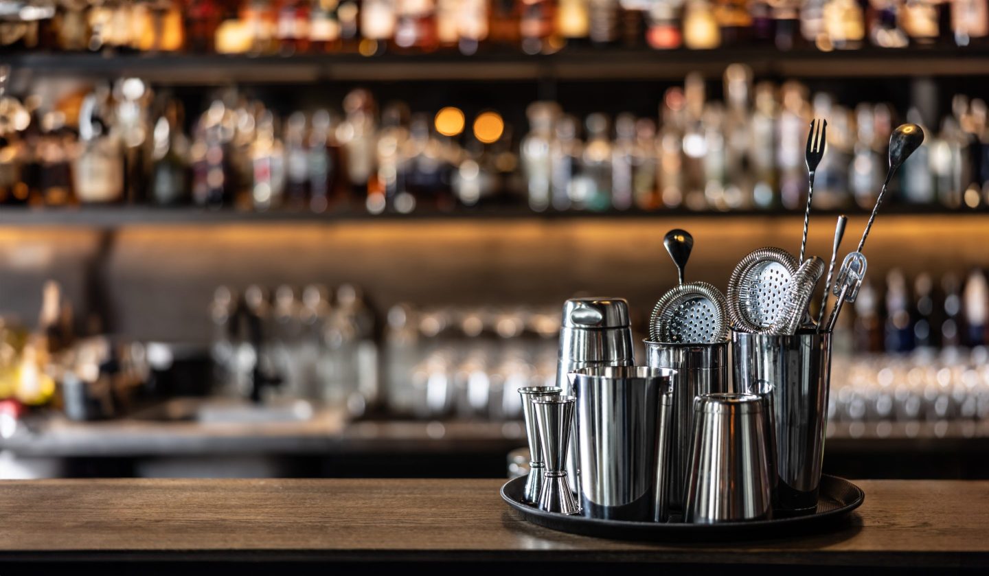 Barmans tools, cocktail shaker and classic equipment for preparing drinks on bar conunter.