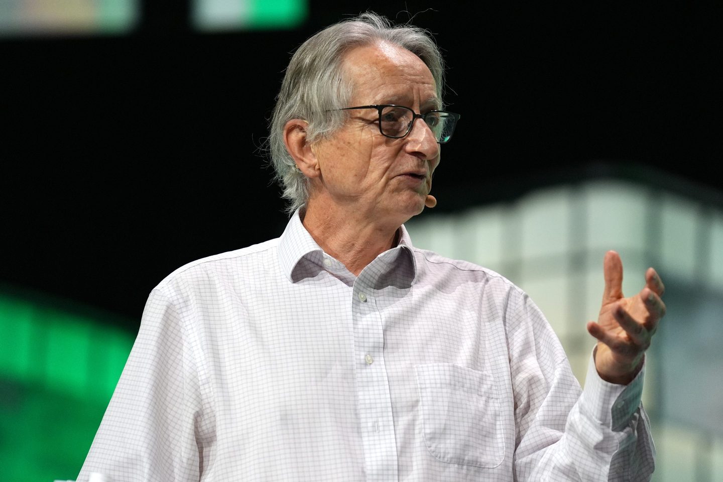 Geoffrey Hinton speaking on stage during a conference