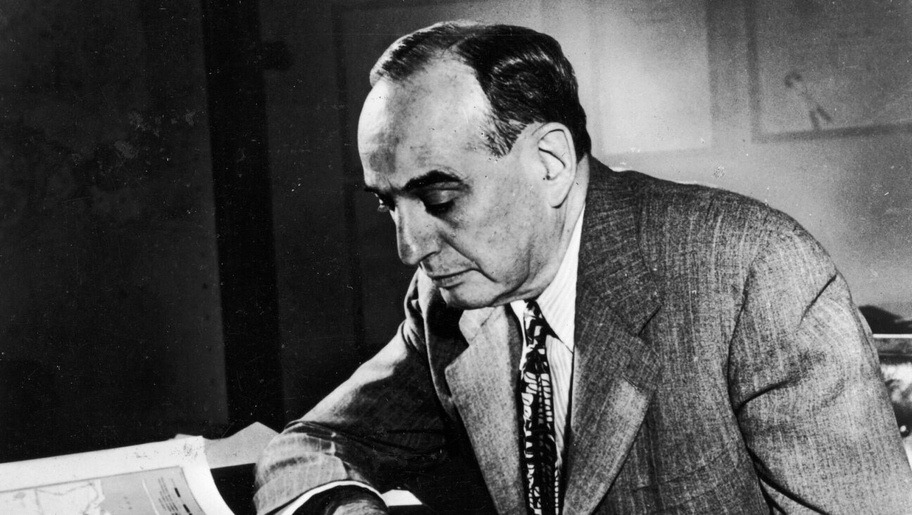 Robert Moses works with a map at his desk, 1958. 