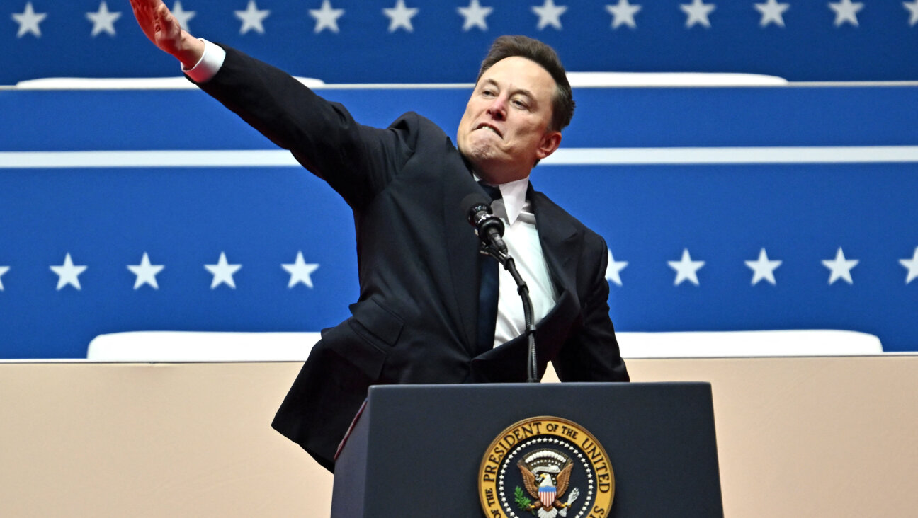 Elon Musk gestures as he speaks during the inaugural parade inside Capitol One Arena.