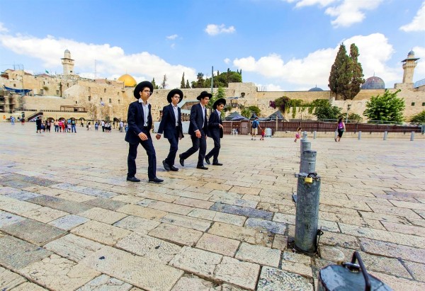 Ultra-Orthodox teens walk together at the Kotel (Western Wall) Plaza in Jerusalem.