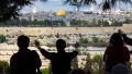 A Christian tourist on the Mount of Olives prays for the peace of Jerusalem.